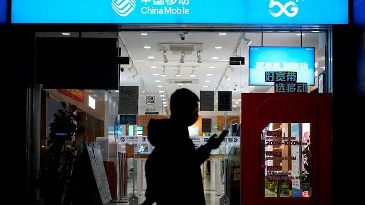 China Mobile shares edge higher in Shanghai debut
