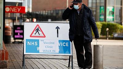 Britain reports record COVID-19 prevalence as Omicron surges