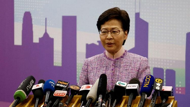 Hong Kong leader orders probe of 13 officials who went to COVID-hit party