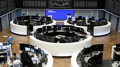 Defensive stocks drive European shares lower on virus, monetary policy worries