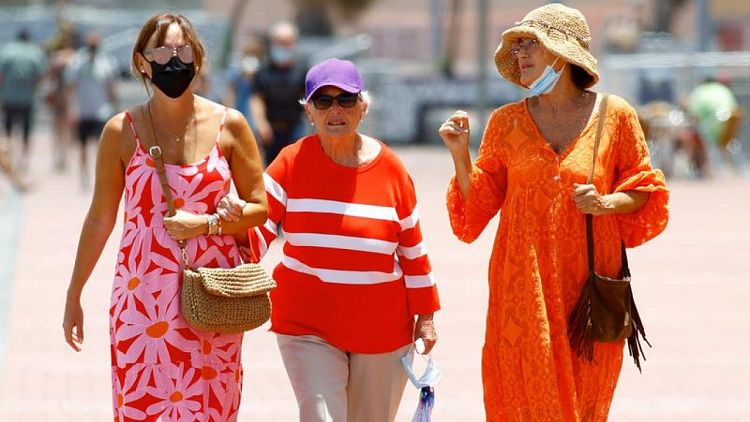 Spain scraps outdoor masks but many choose to keep them on