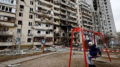 Kyiv residents clear away rubble and await Russian assault