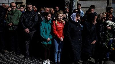 Ukrainian mourners ignore missile risks to attend military funerals