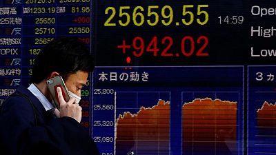 Asian shares slide on Fed's aggressive tightening stance