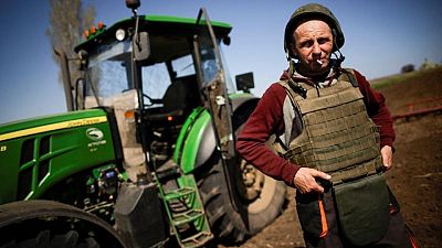 Ukrainian farmers don bulletproof vests to plough frontline fields