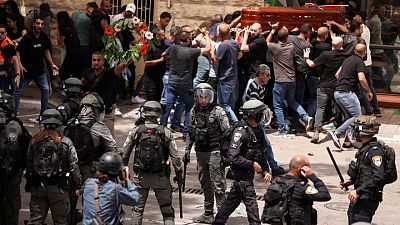 Police clash with mourners at Palestinian journalist's funeral Police clash with mourners at Palestinian journalist's funeral