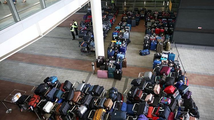 Luggage piles join long airport lines in fresh woes for summer travel