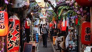 Japan warns of COVID surge, Tokyo raises alert level