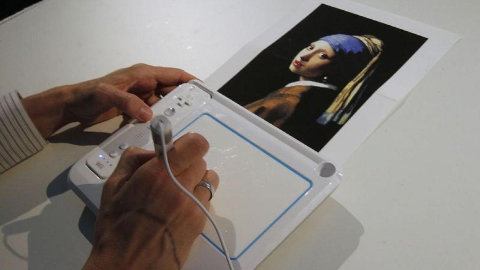 Activist glues his head to 'Girl with a Pearl Earring' painting in The Hague