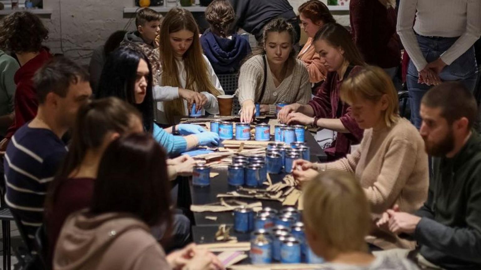 Ukrainian volunteers make 'trench candles' for troops from tin cans