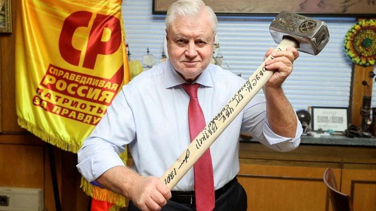 Russian politician poses with sledgehammer in tribute to Wagner mercenaries